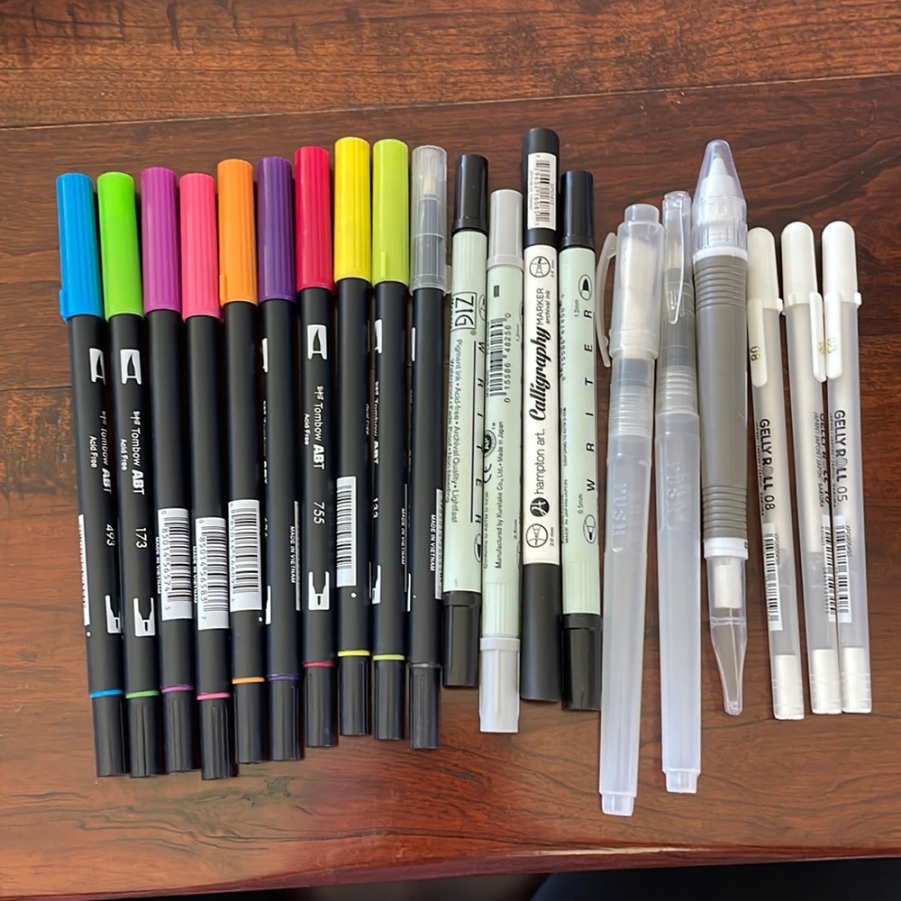 Tombow pens, watercolor brushes, Gelly Roll white pens, and misc pens.